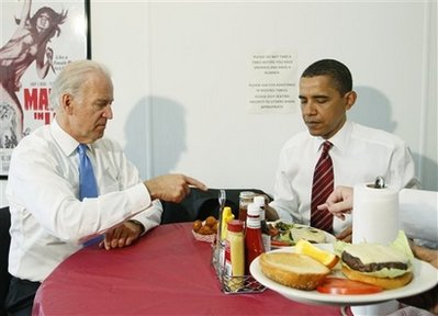 President Barack Obama and Vice President Joe Biden are served their burgers as they make an unannounced visit to Ray's Hell Burger in Arlington, Va., to have lunch, Tuesday, May 5, 2009. (AP Photo/Charles Dharapak)
